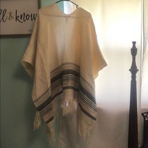 Ponchos. Grey and one is cream with stripes.